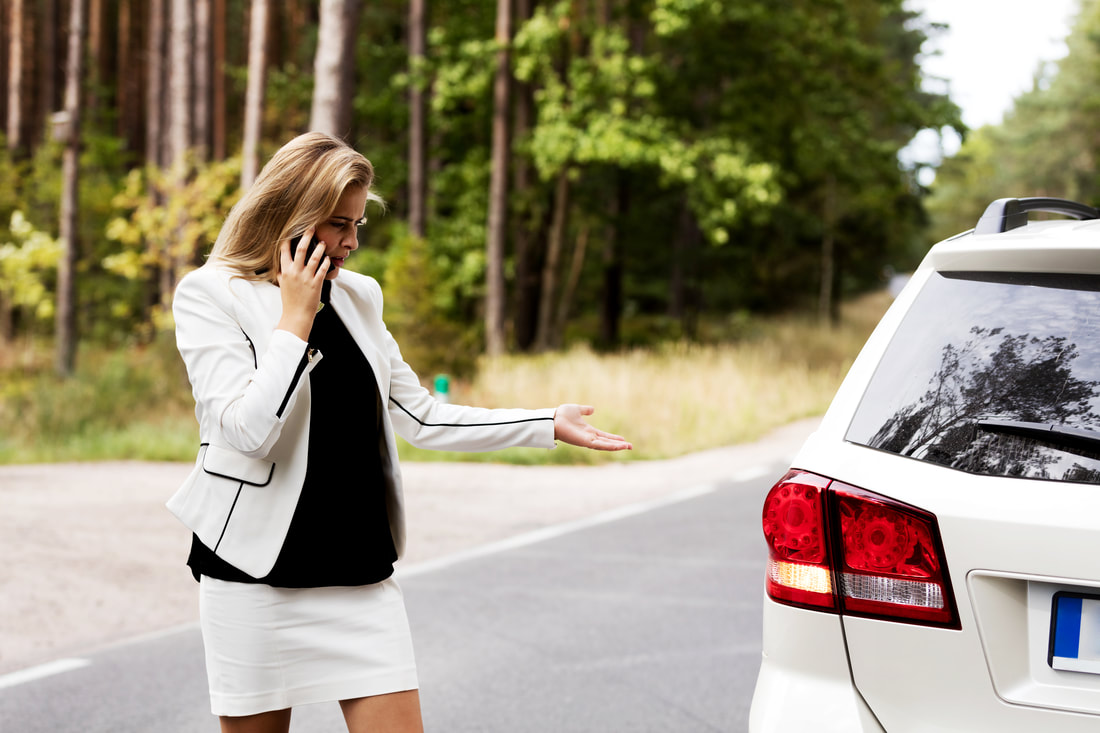 business woman calling for tow