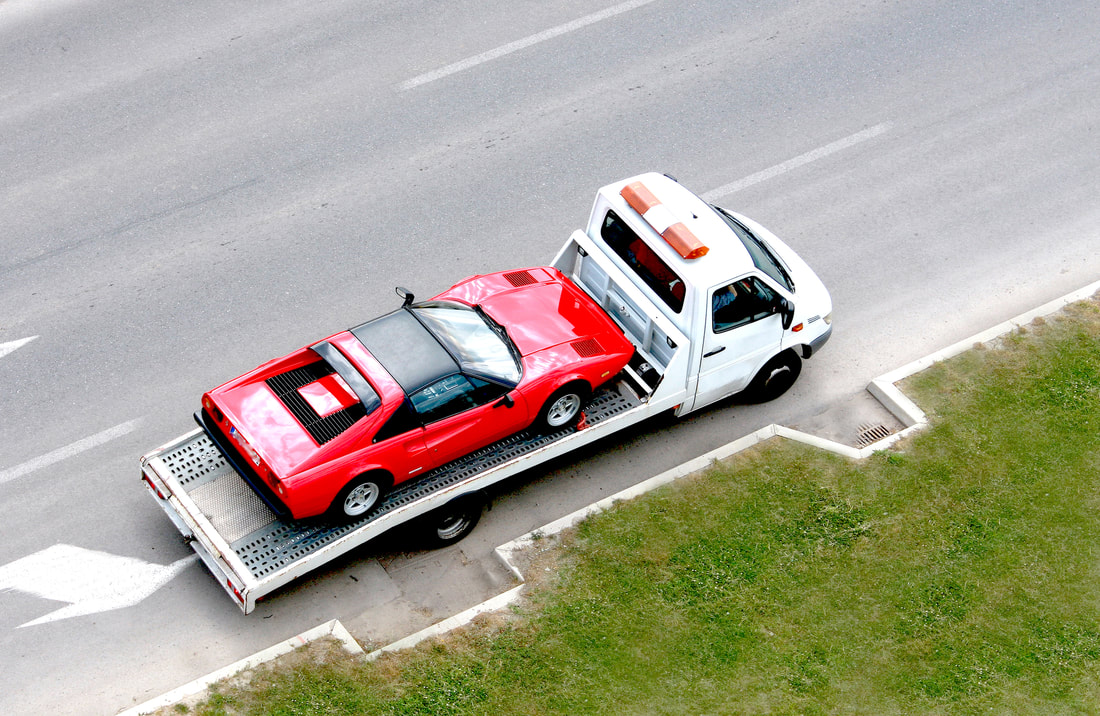 brockton towing, ferrari on flatbed tow truck tagged