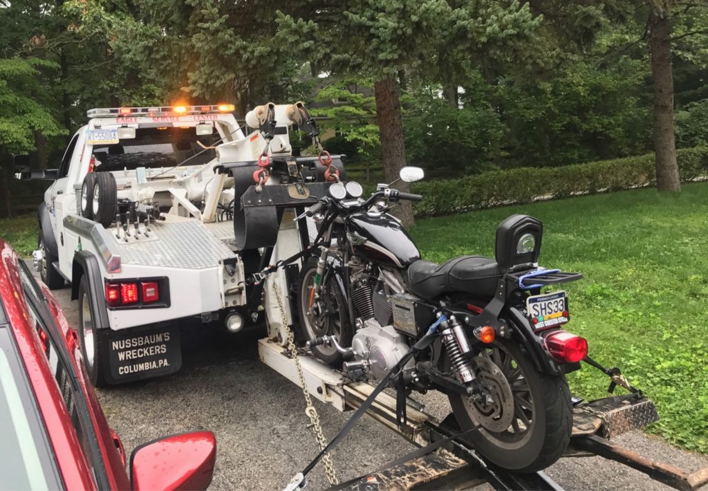 Motorcycle towing on wheel lift tow truck